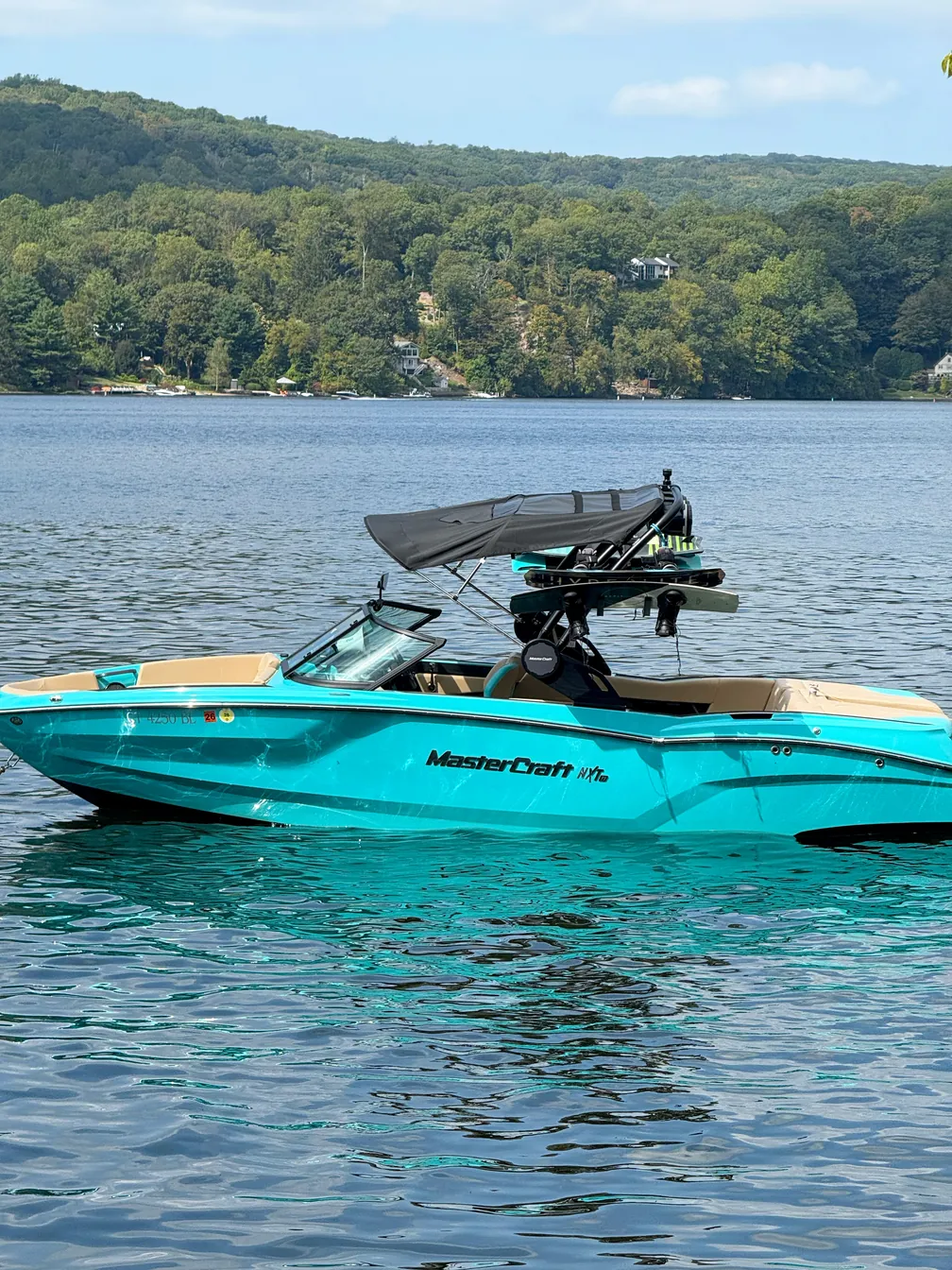 Teal and tan 2026 MasterCraft NXT23 Diamond edition at the dock on Candlewood Lake