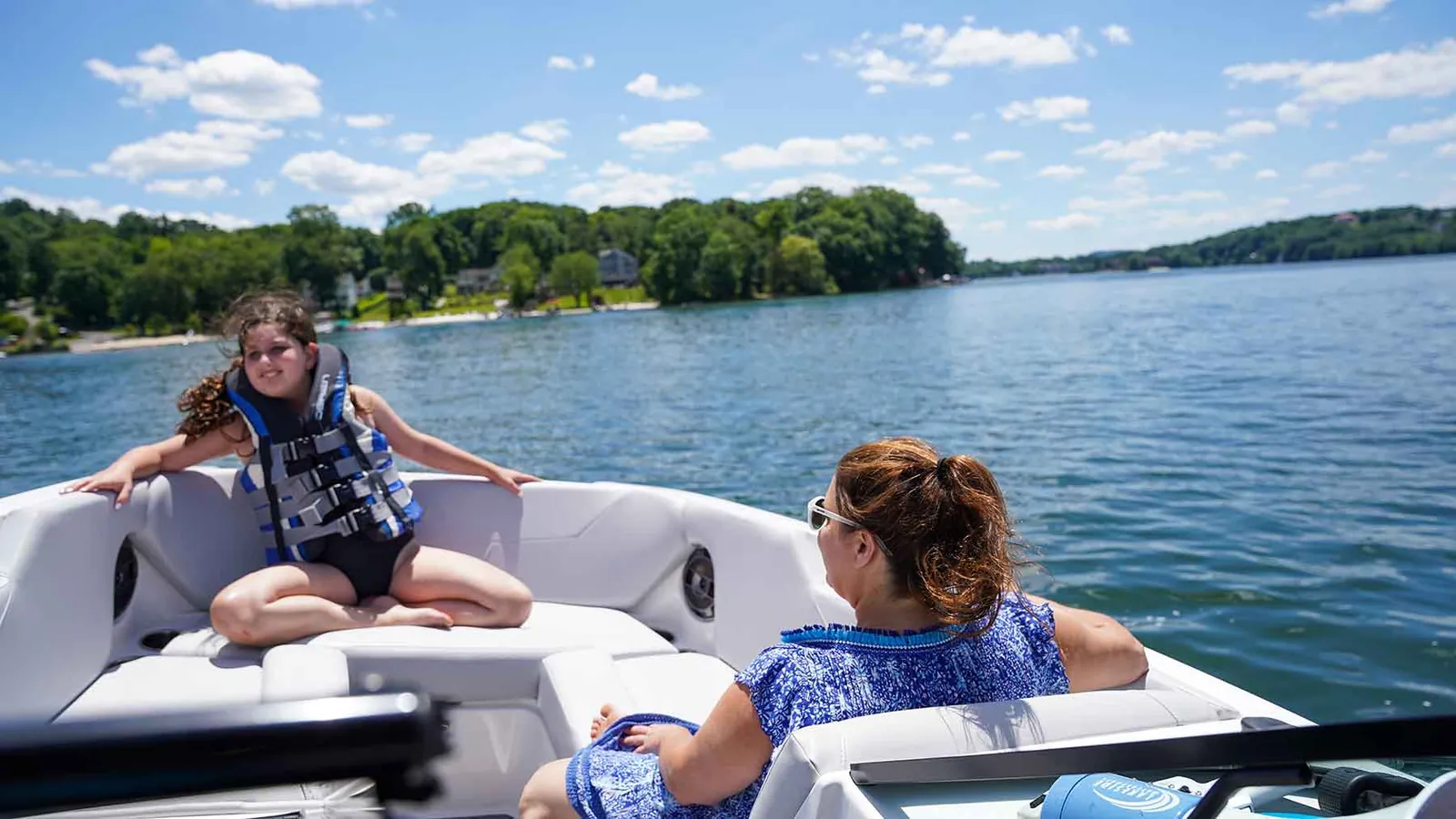 Mom and daughter relaxing on a boat ride across Candlewood Lake