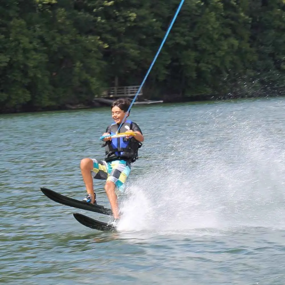 Young child up on water skis during a lesson on Candlewood Lake