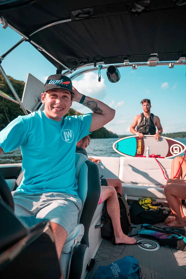 A smiling Lakeside Watersports captain driving the boat