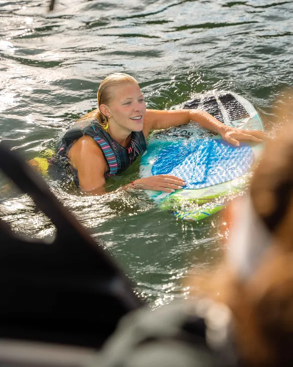 Lakeside Watersports staff member helping a rider with a board in the water