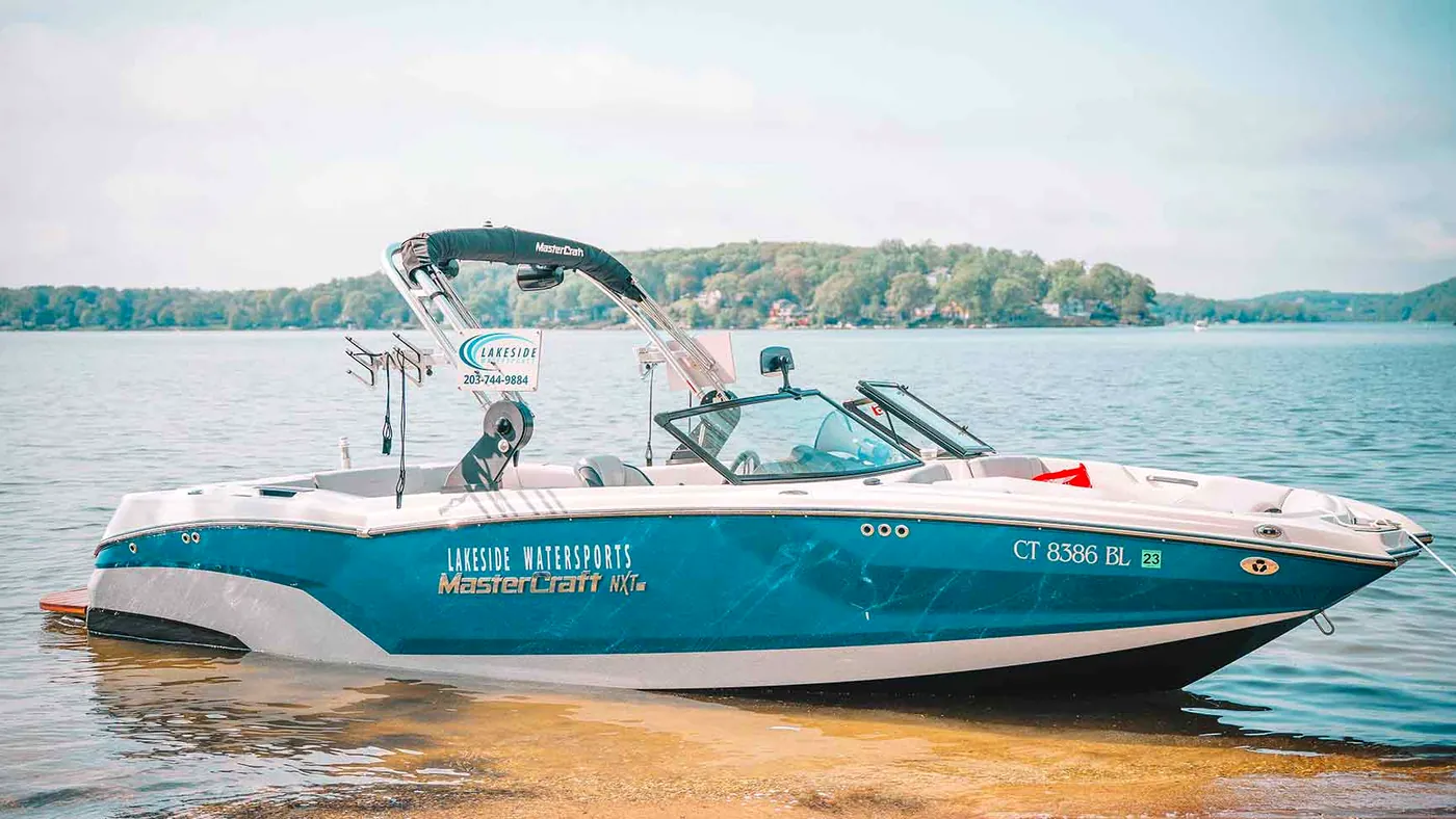 A Lakeside Watersports MasterCraft NXT wake boat on the Candlewood Lake shoreline in Connecticut