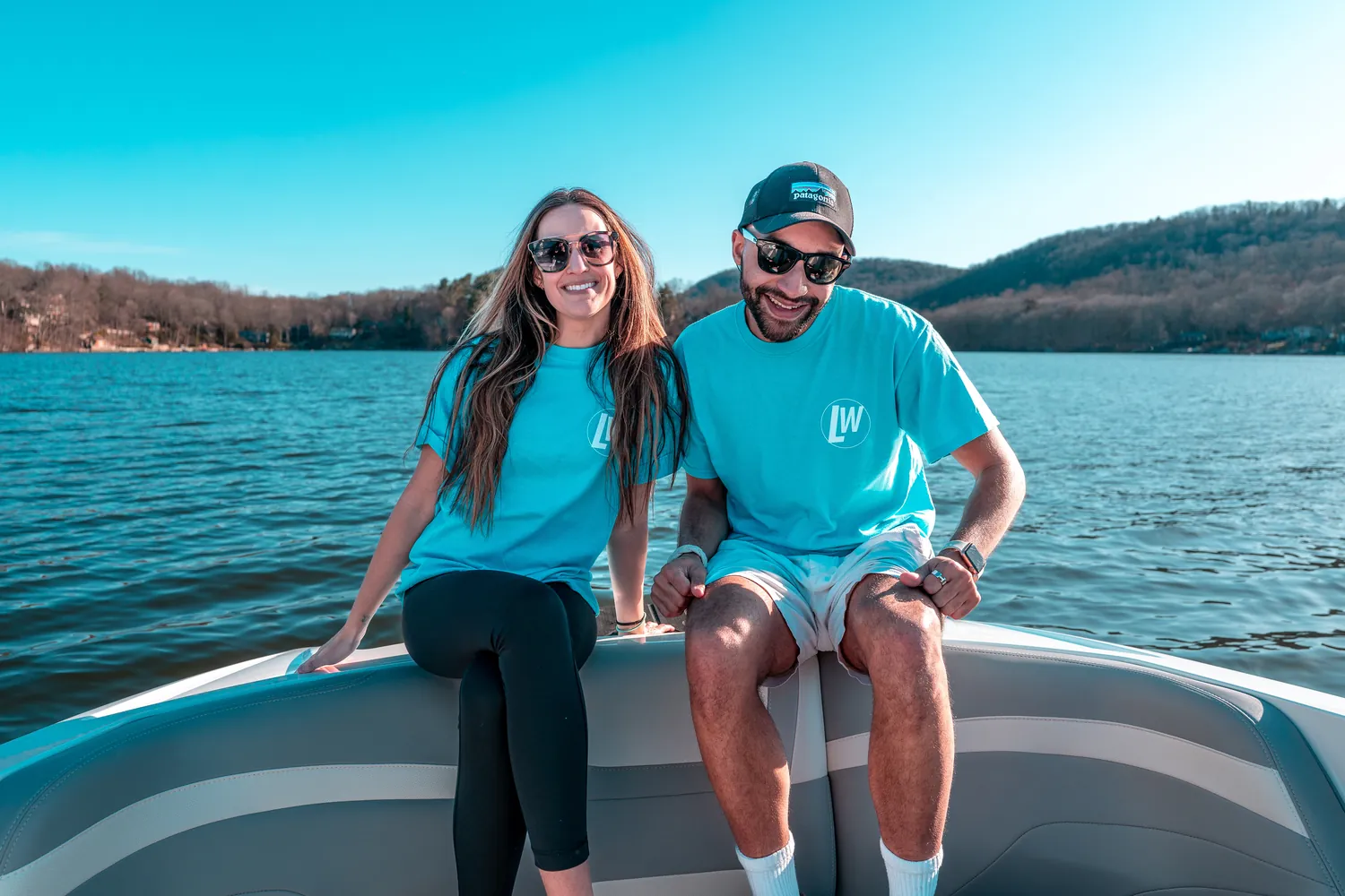 Two Lakeside Watersports staff members on the bow in team shirts