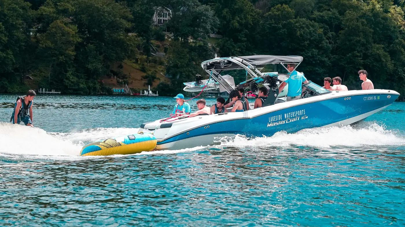A Lakeside Watersports wake boat pulling a rider on Candlewood Lake