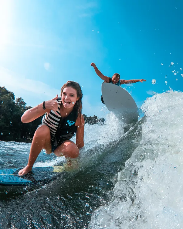 Wakesurfer carving the wave behind a Lakeside Watersports boat on Candlewood Lake