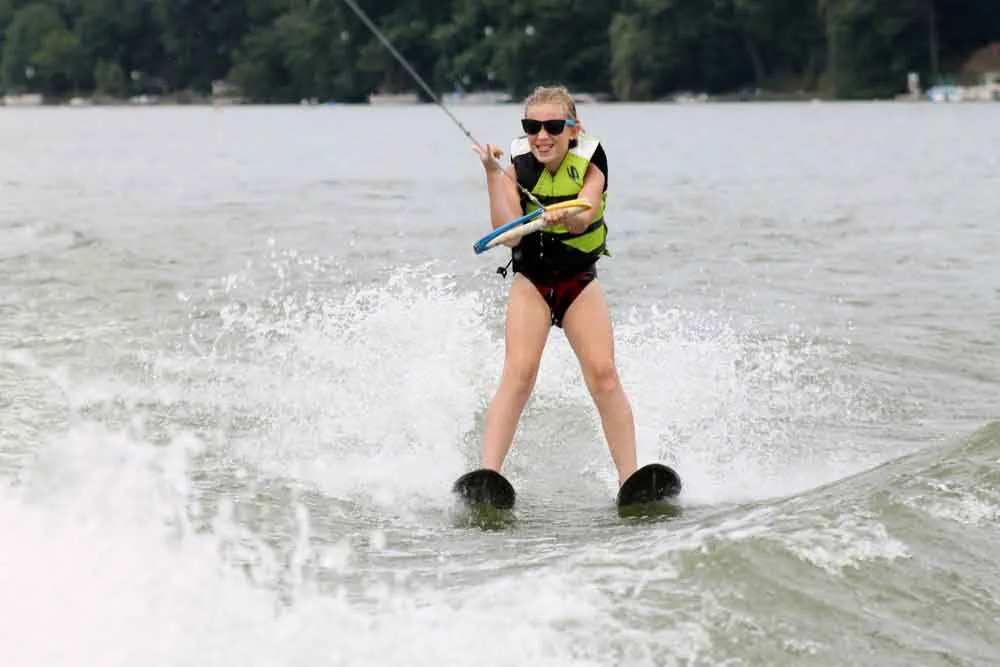 Young water skier holding the handle behind the boat on Candlewood Lake